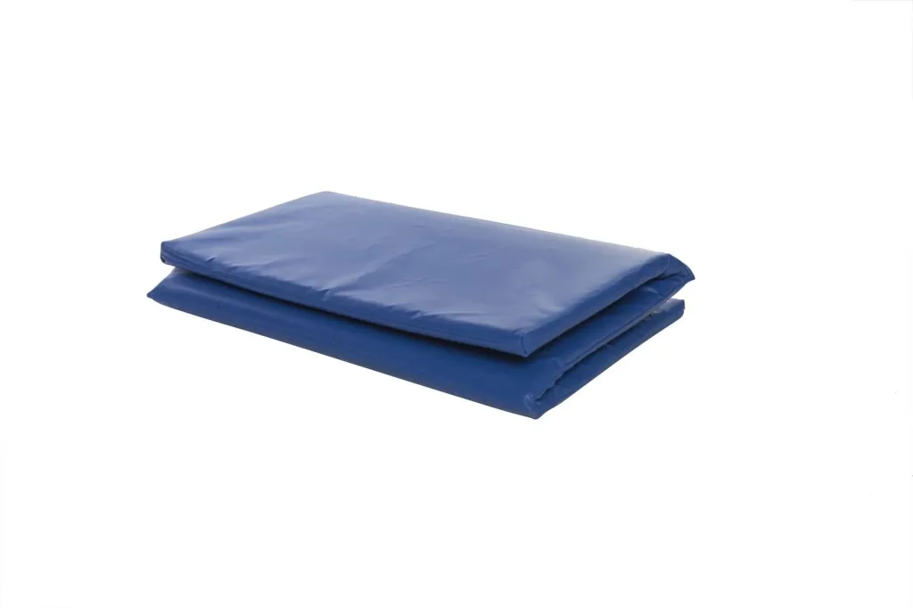 Blue folding sleep mat with foam core and phthalates free PVC cover, folded twice on a white background.