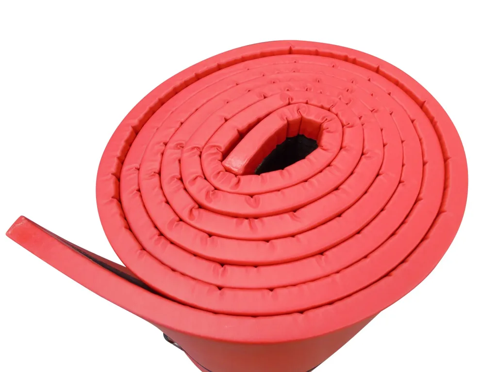 Rolled red agility mat with leather-effect PVC cover, recycled chipfoam core and visible spiral roll.
