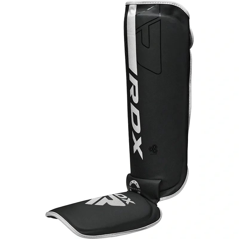Black shin and instep guard with white trim and printed RDX text along the front.
