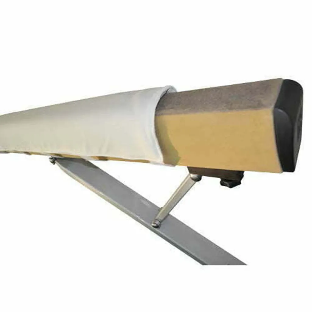 Balance beam extension with white fabric padding partially covering beige foam and a black end cap, mounted on a gray metal support.