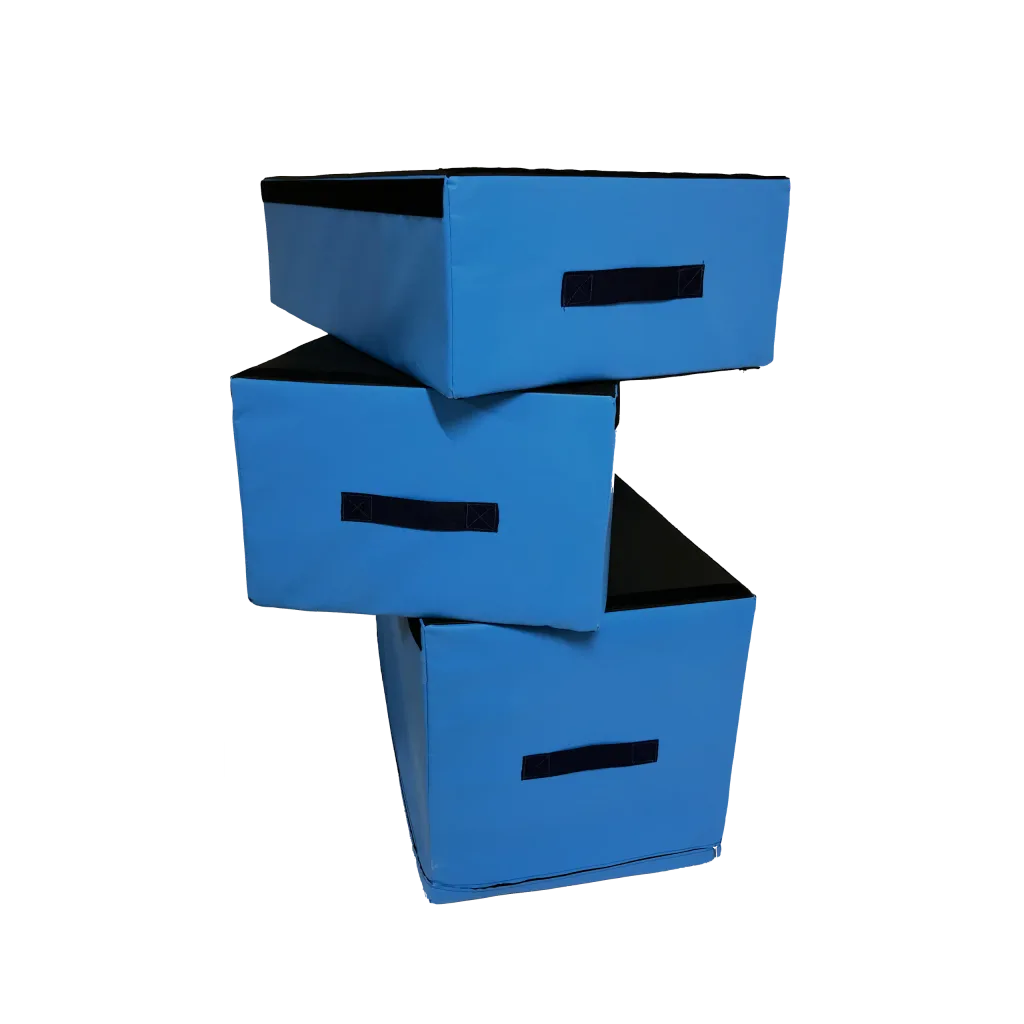 Three blue PVC-covered rectangular jumping blocks stacked staggered, each with a black stitched carry handle and black top panel.