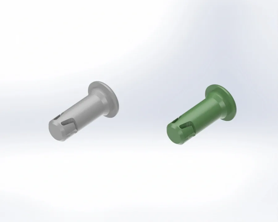 Two cylindrical plastic connectors on a white background, one gray and one green, each with a flanged head and slotted tip.