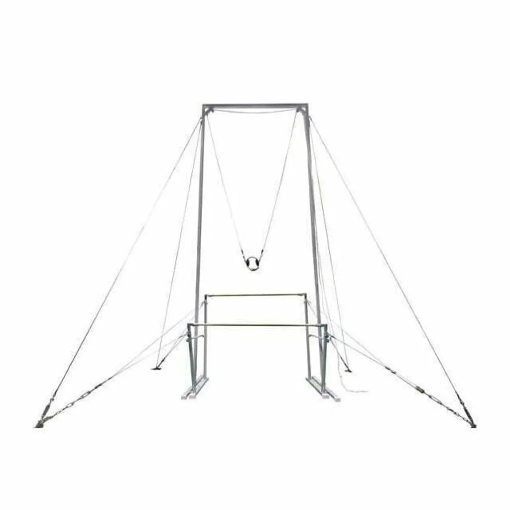 Tall metal coaching rig with a pulley and hanging harness above uneven bars, anchored by taut support cables to the ground.