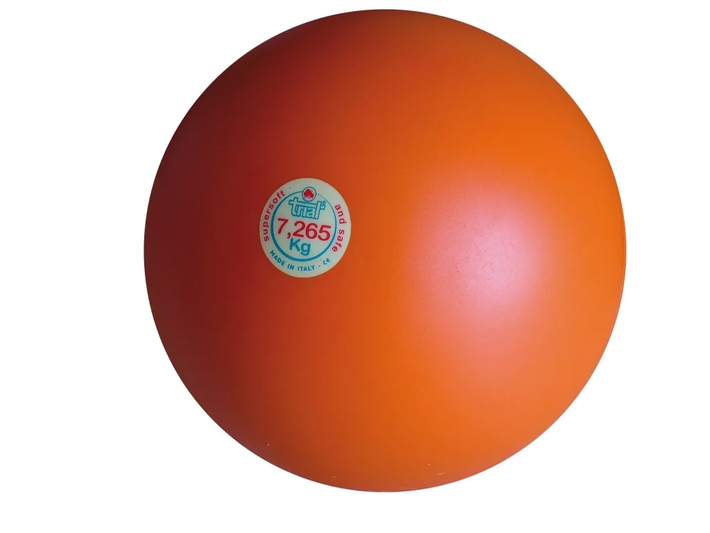 Orange indoor shot put with small round sticker reading "7,265 Kg".