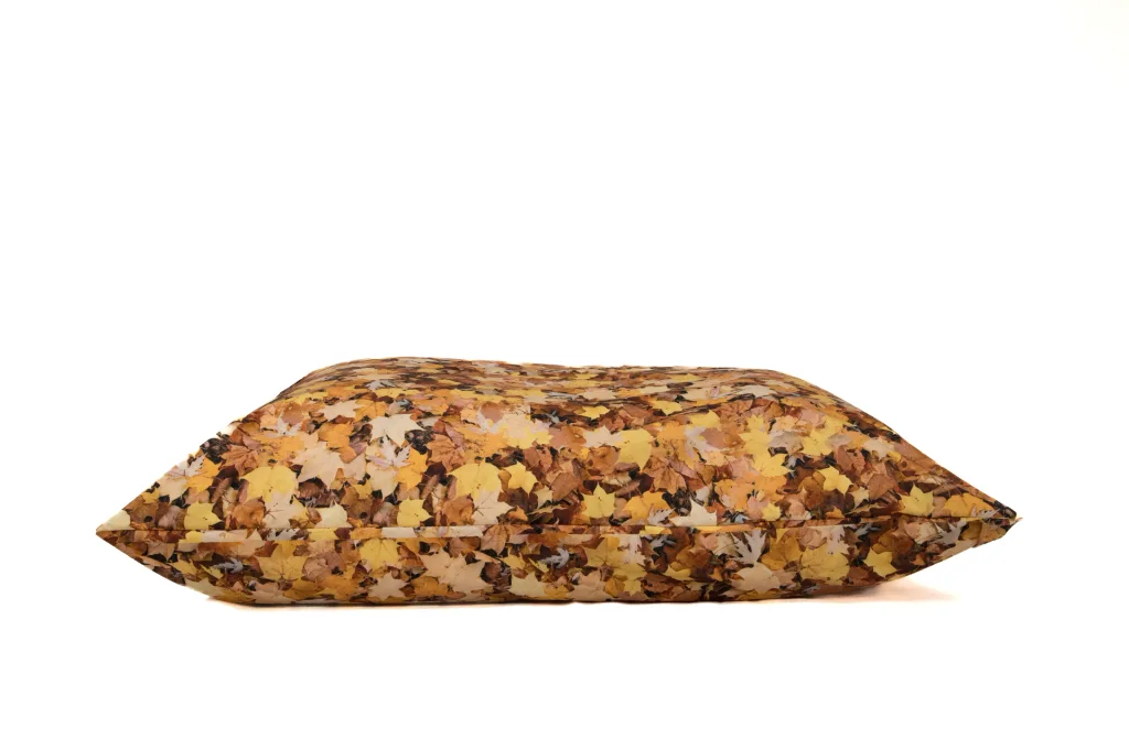 Medium floor cushion with outer cover made from 100% polyester and a nature leaf print, shown lying flat.