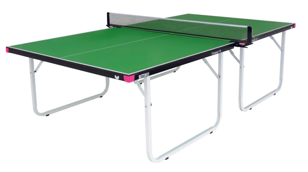 Table tennis table with green playing top, steel frame with magenta corner pieces, light silver folding legs, center net and Compact 19 on the edge.