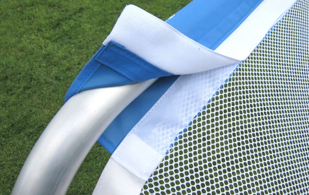Aluminium goal frame with blue fabric sleeve and white mesh net on green grass.