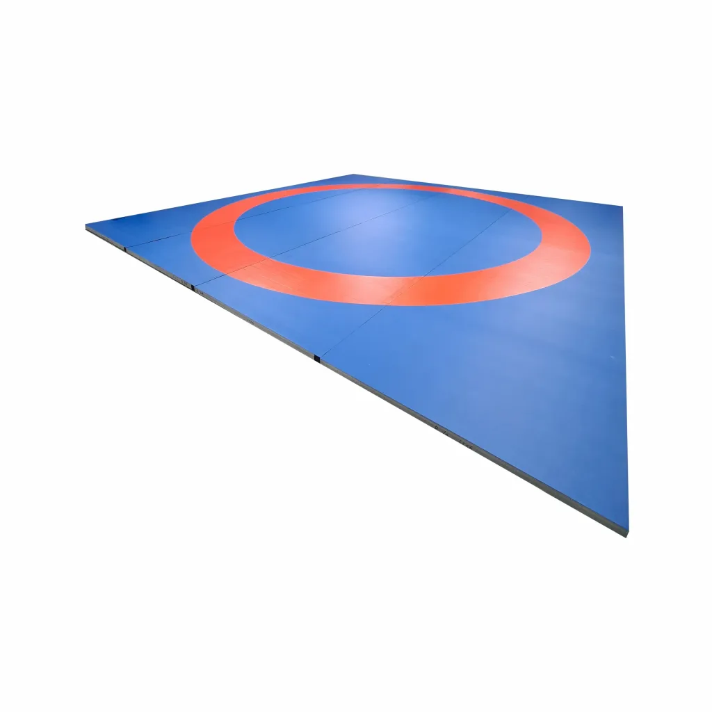Blue wrestling roll out mat area with a red circular ring and visible panel seams.