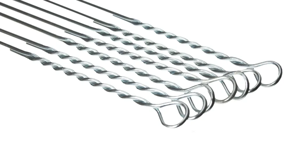 Several galvanized steel hammer wires with twisted shafts and looped ends on a white background.