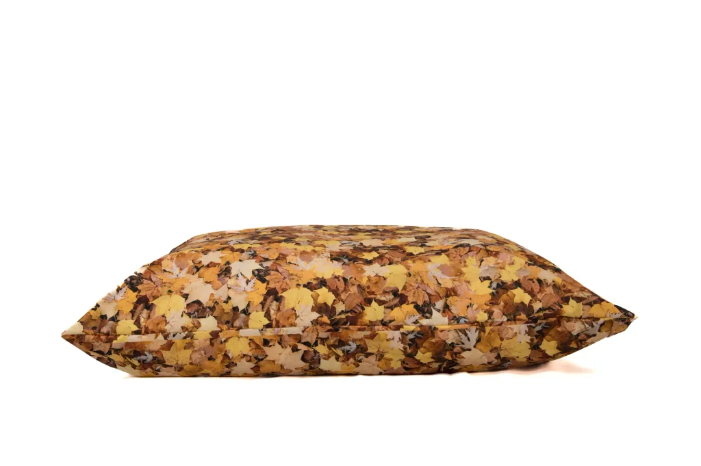 Large floor cushion with nature leaf print and polyester cover in yellow and brown tones, shown against a white background.