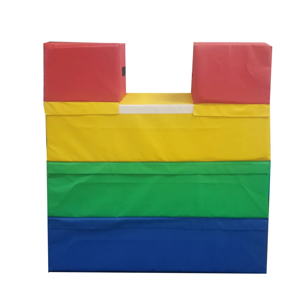 Four-section foam vaulting box with flame-retardant PVC covers in red, yellow, green and blue, with a U-shaped top cutout.