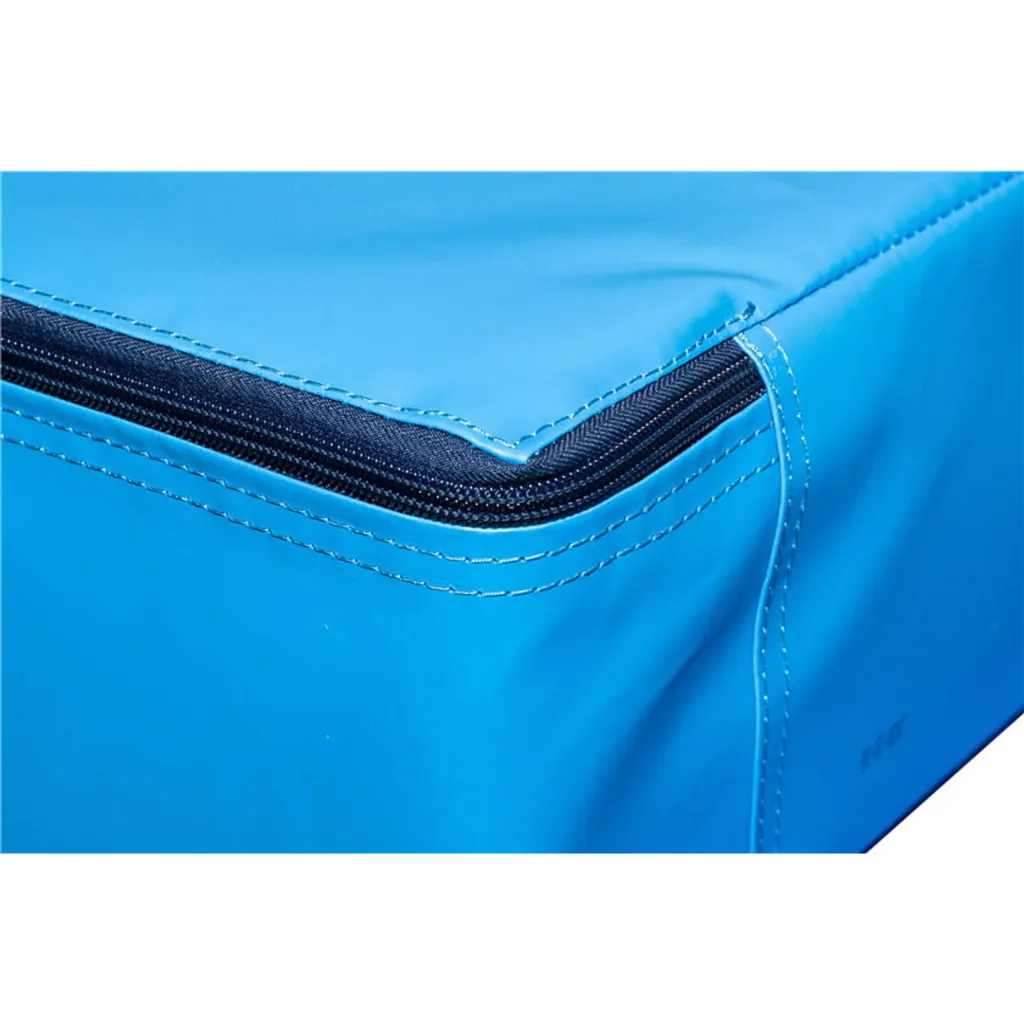 Blue uneven bars landing mat corner showing a black zipper along the top edge and white stitched seams.