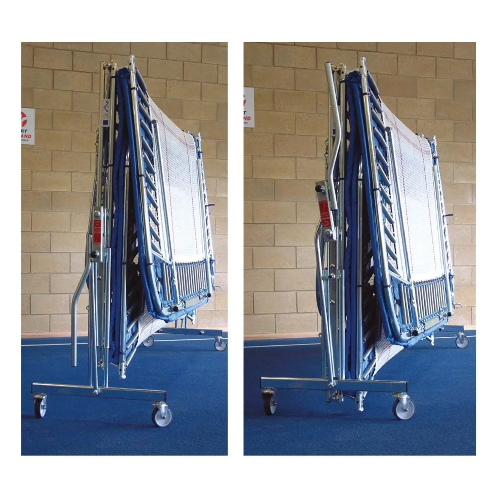 Folded club trampoline with 6mm/13mm webbed bed and coverall pads mounted on lift/lower roller stands.
