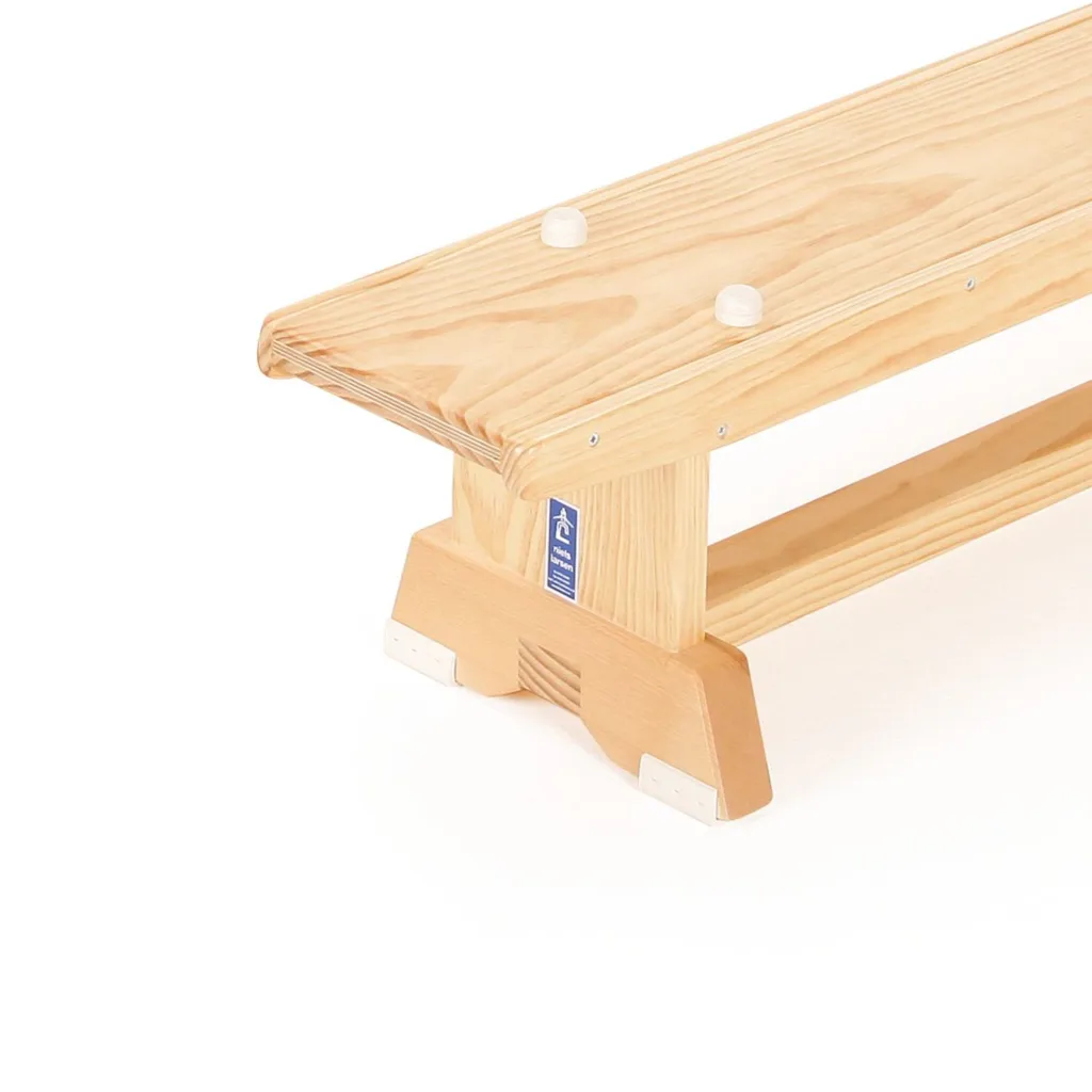 Kiln-dried pine balance bench top showing two white rubber buttons and dovetail-joined leg support.