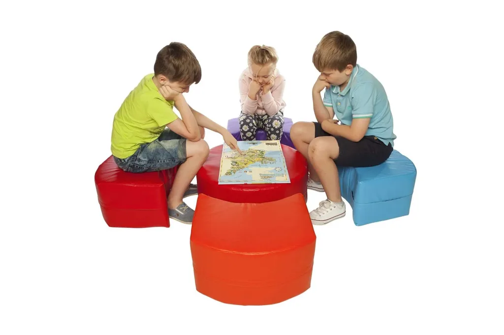 Three children sit on foam-filled PVC modular seating pods in assorted colors (five pieces) arranged around a central pod and study a map.