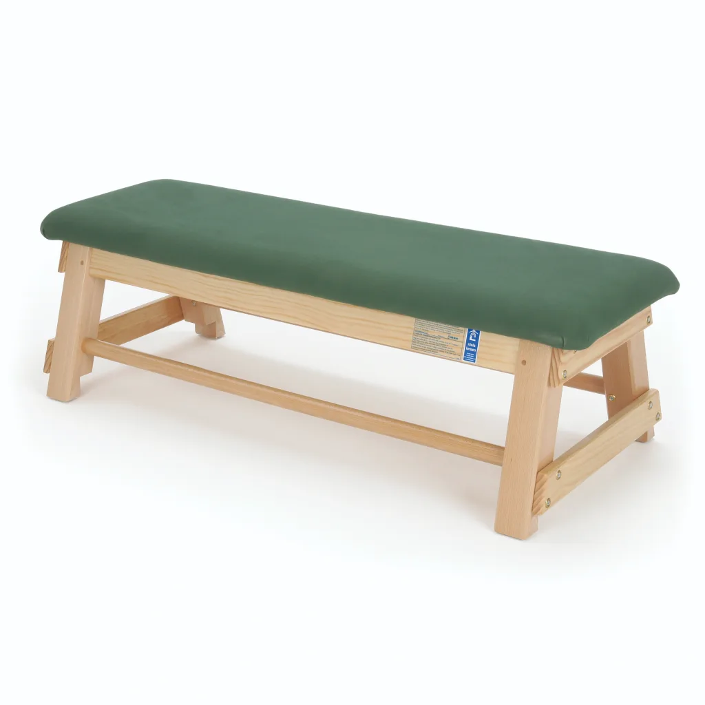 Light wood bench with a green quality hide top, interlocking corner blocks, and castors.