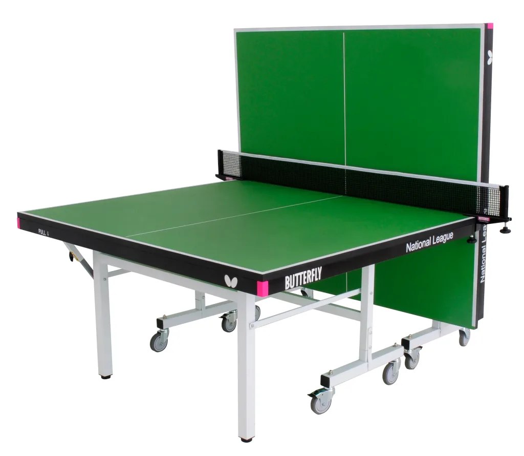 Table tennis table with green playing top, light silver legs and undercarriage, magenta corner pieces, black net and caster wheels.