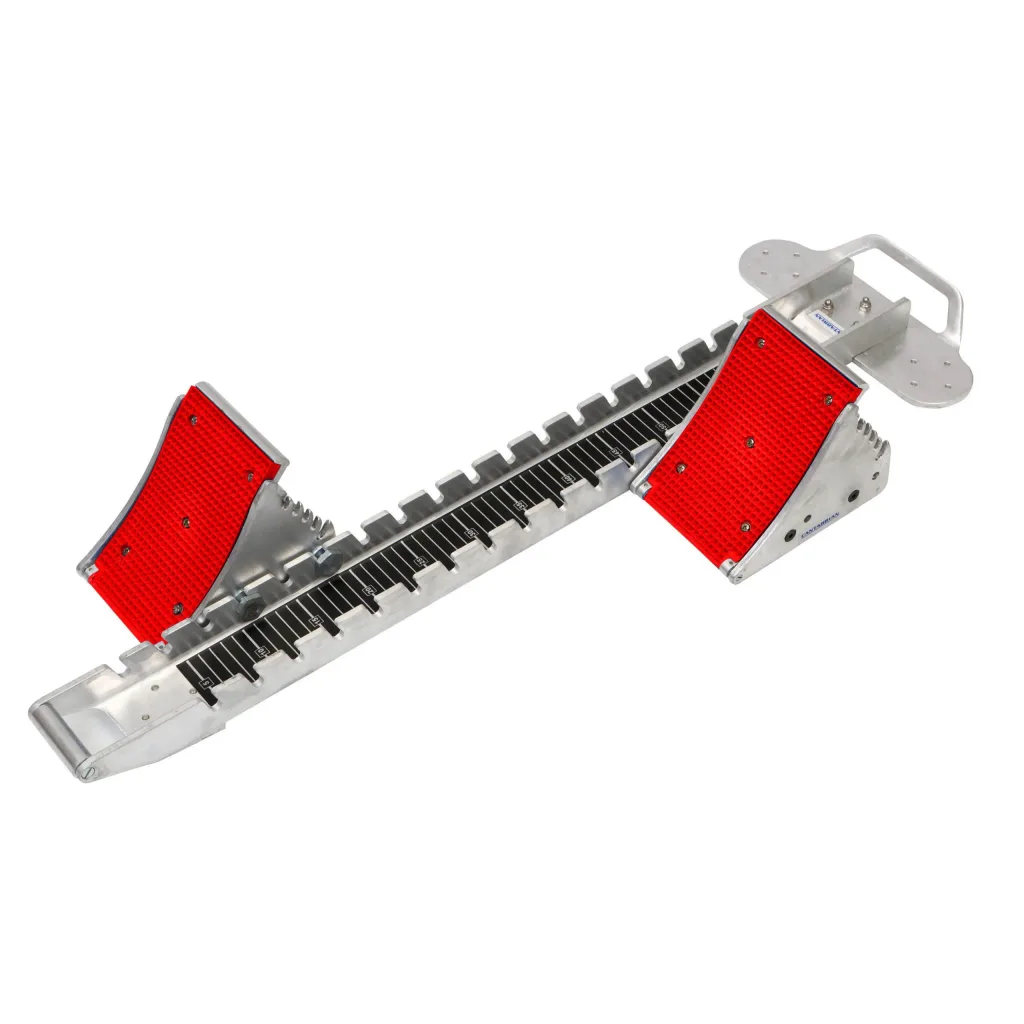 Aluminium starting blocks with red textured footplates and a black centre bar with white measurement markings.
