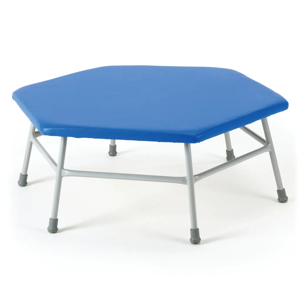 Hexagonal movement table with a blue vinyl-covered top over flame-retardant foam, grey powder-coated steel legs and non-marking rubber feet.