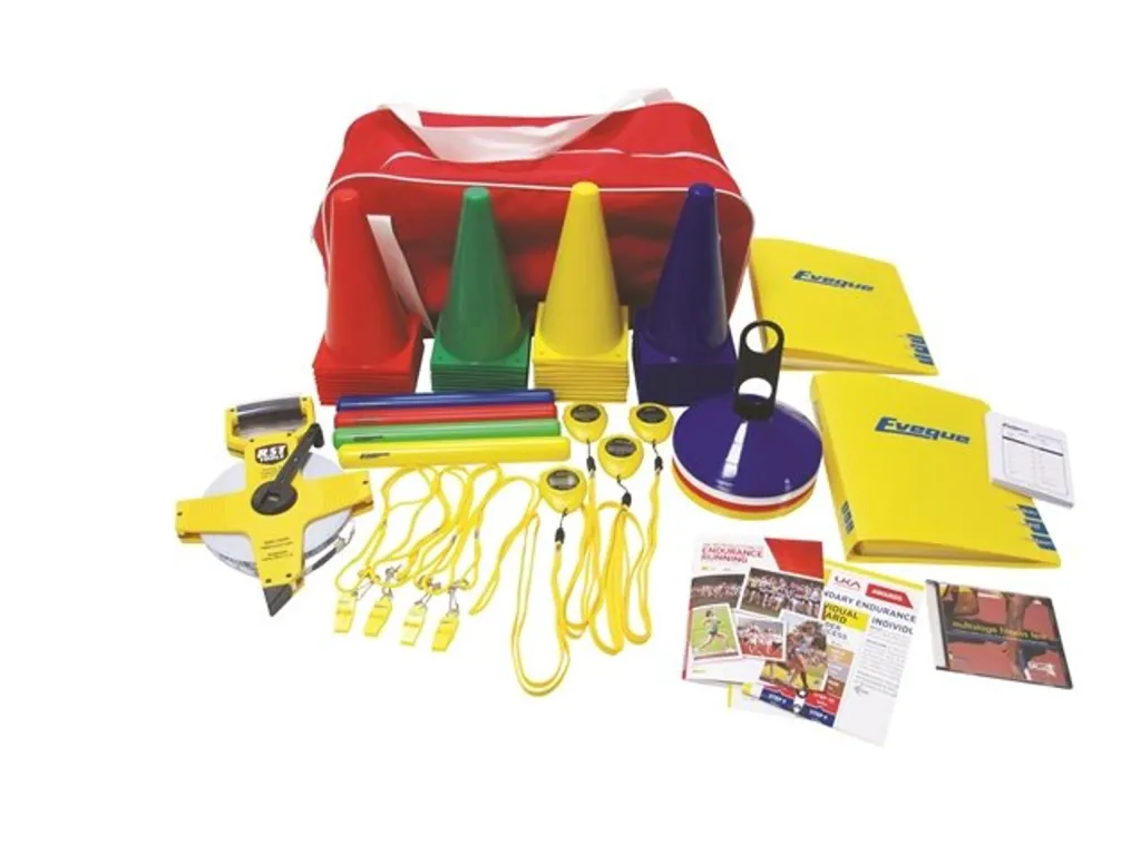 Red carry bag with a youth athletics kit arranged in front: colored cones, stacked marker discs, rods, yellow stopwatches, whistles and folders.