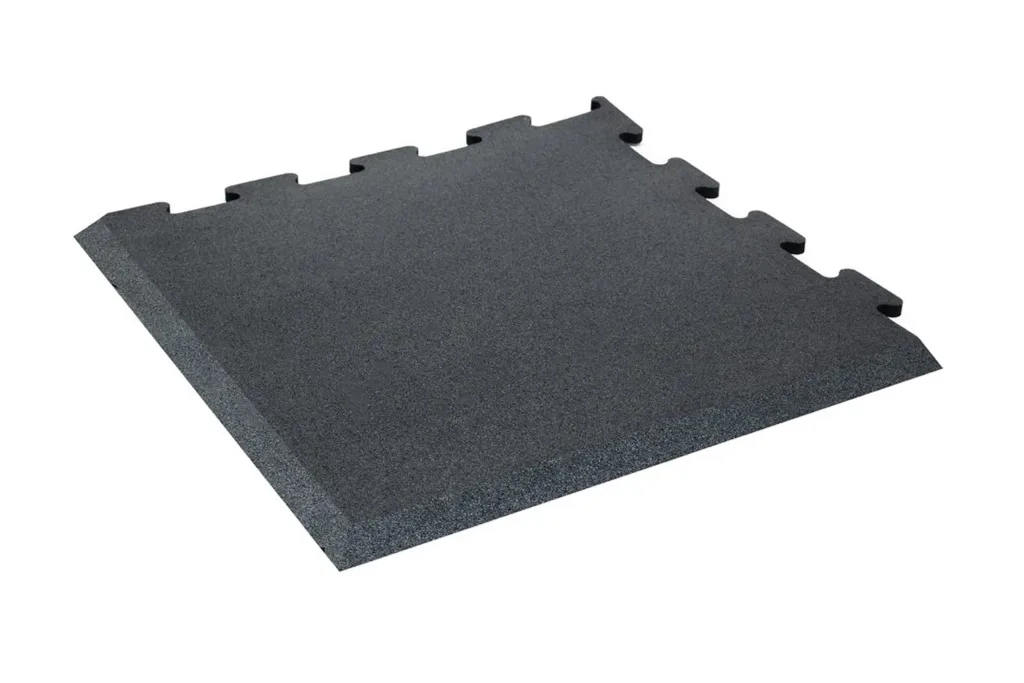 Dark gray interlocking rubber floor tile with jigsaw connectors on two sides and a beveled ramped edge.