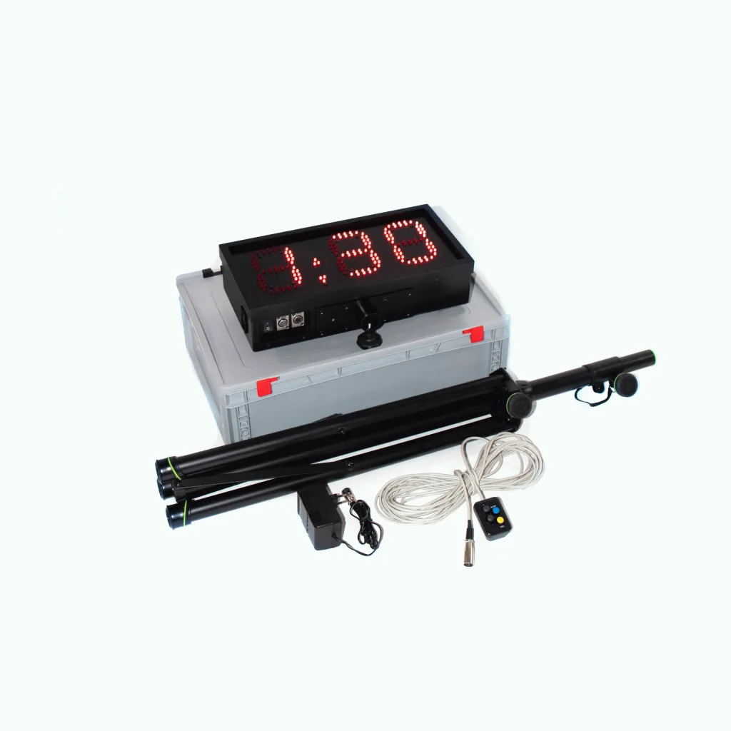 Black countdown clock displaying 3:30 in red LED digits on a gray transport case, with folded black tripod, coiled cable, remote and charger.