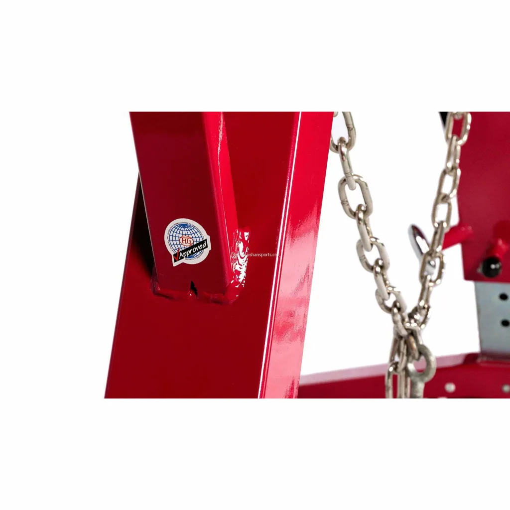 Red steel leg of a pommel horse base with a small round FIG Approved sticker and hanging metal chains.