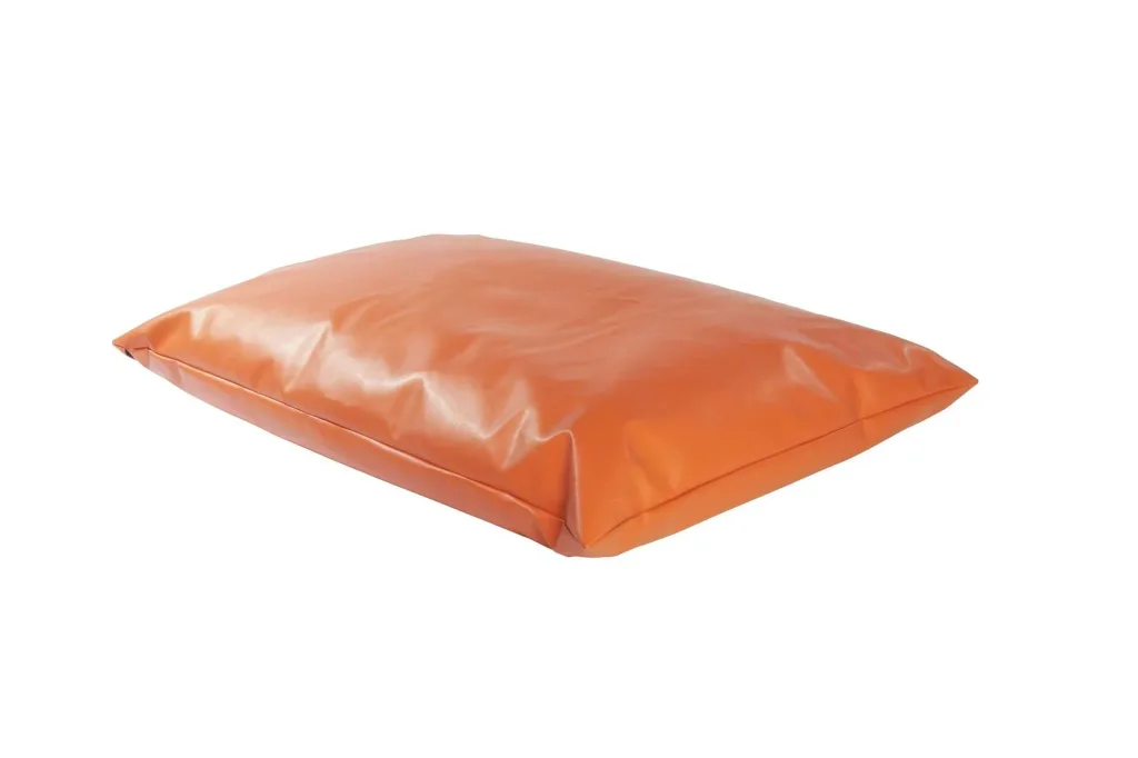 Rectangular giant child floor cushion in burnt orange faux leather on a white background.