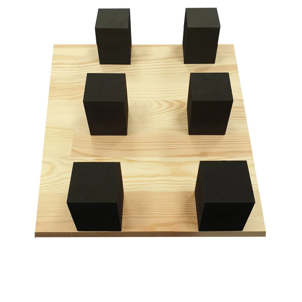 Six closed-cell PE foam blocks arranged in three rows on a light plywood board.