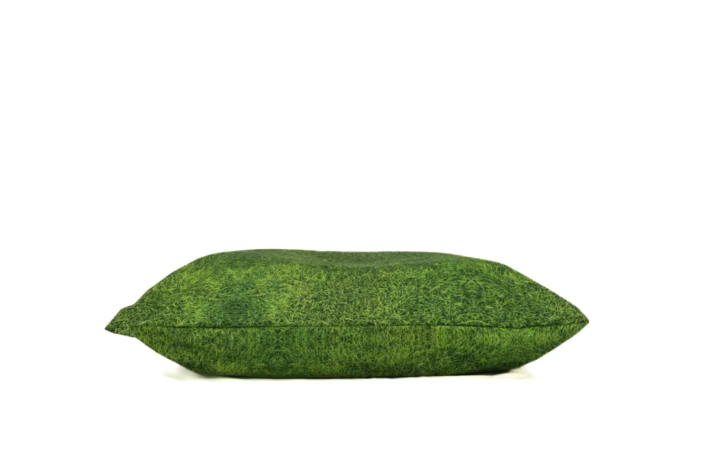 Nature print medium floor cushion with green grass-patterned outer cover made from 100% polyester, shown lying on its side.