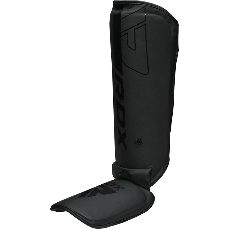 Black shin and instep guard with RDX printed on the front, standing upright and showing the attached foot pad.