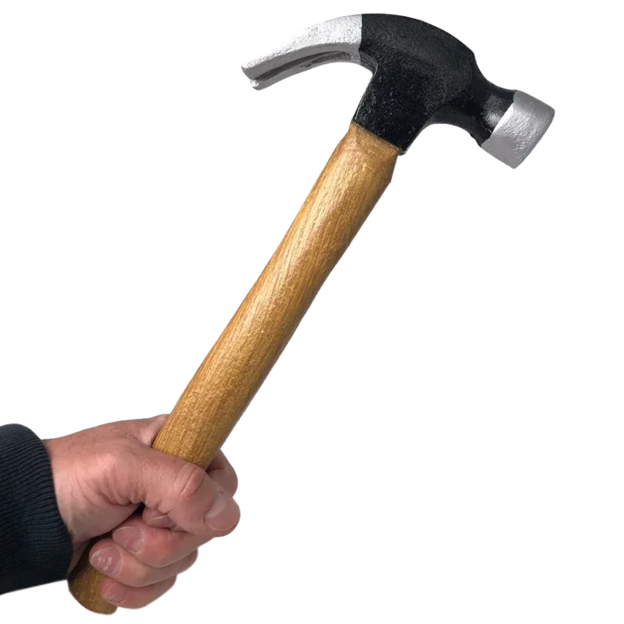 Hand holding a PU foam claw hammer training prop with a wood-effect handle and black-and-silver head.