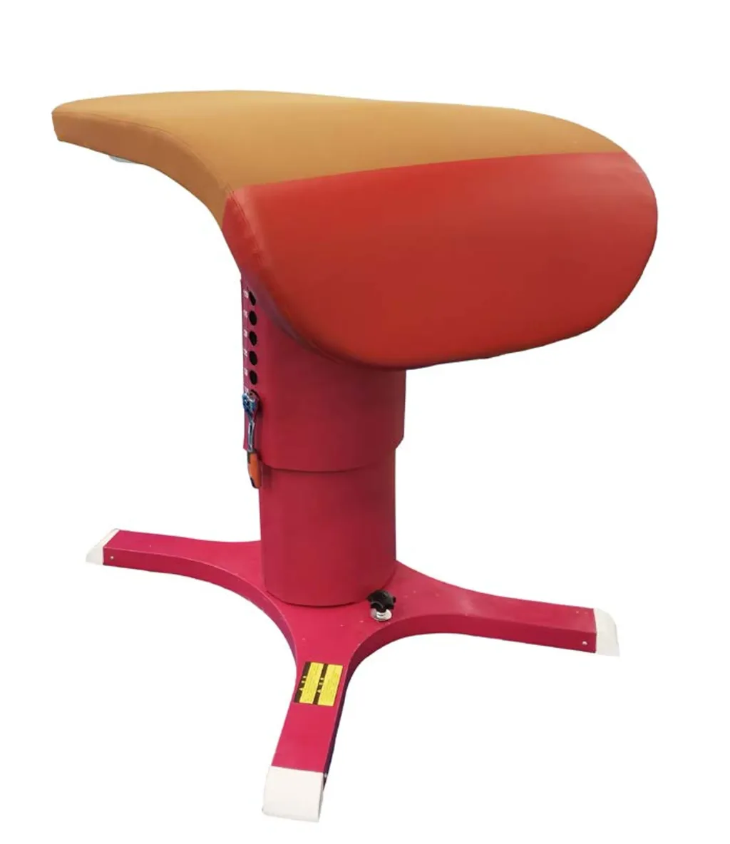 Red competition vaulting table with tongue-shaped padded top, single central adjustable column, and four-legged base.