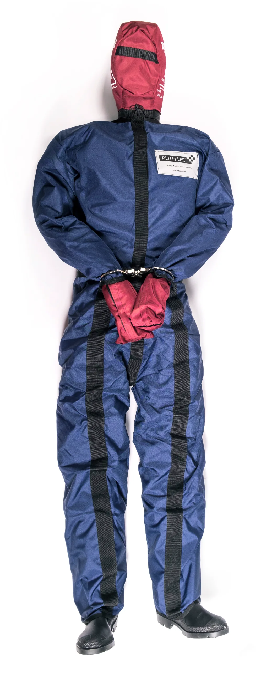 Prisoner security manikin in navy overalls with red hood and mitts, hands handcuffed behind back and "RUTH LEE" label on chest.