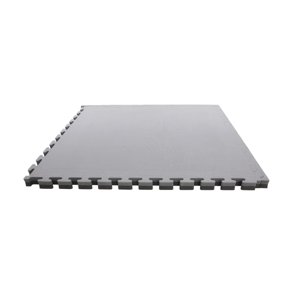 Grey and black reversible EVA foam jigsaw mat with interlocking T-shape edges and textured surface lying flat.