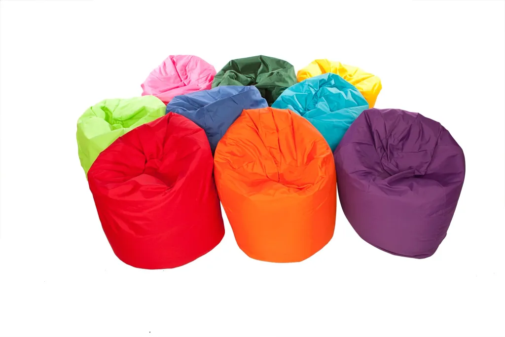 Giant children's bean bags arranged in a cluster in bright assorted colors, each with a removable wipe-clean cover and rounded seating.