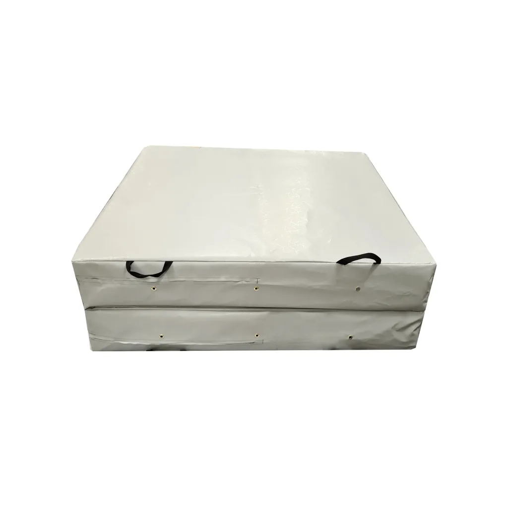Folded safety mat with heavy-duty flame-retardant PVC cover, two black carry handles and metal grommets along the front.