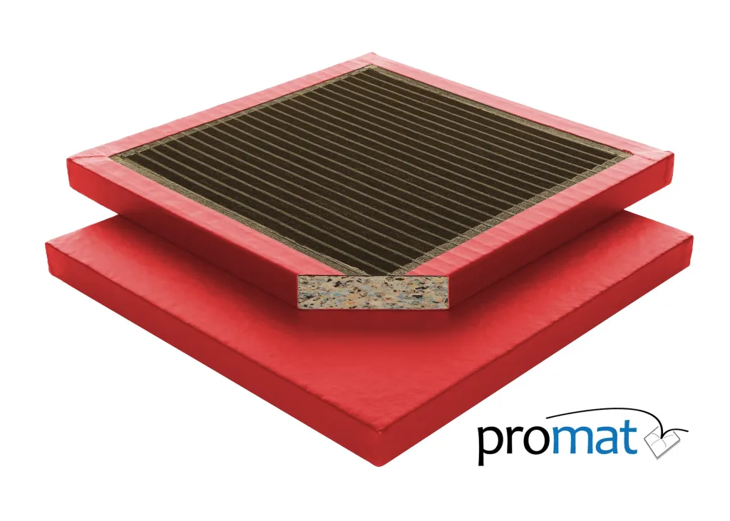 Stacked red multipurpose gym mats, top mat with black ribbed surface and cutaway multicolored chip foam core, "promat" logo visible.