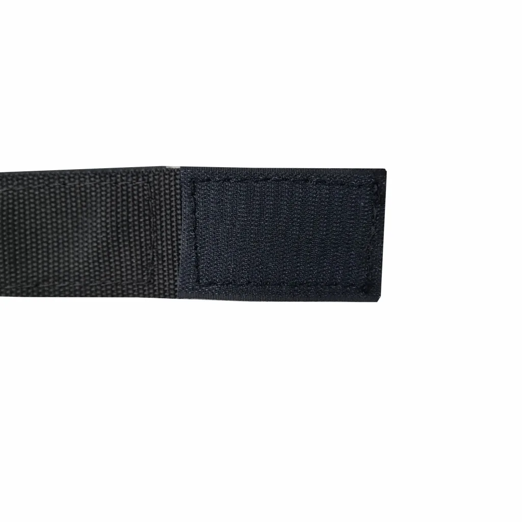 A close-up of a wrestling ankle band showing a square hook-and-loop patch stitched to a woven strap.