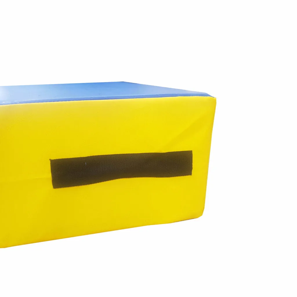 Large foam springboard with a blue top, yellow sides and a black fabric carrying handle visible on the side.