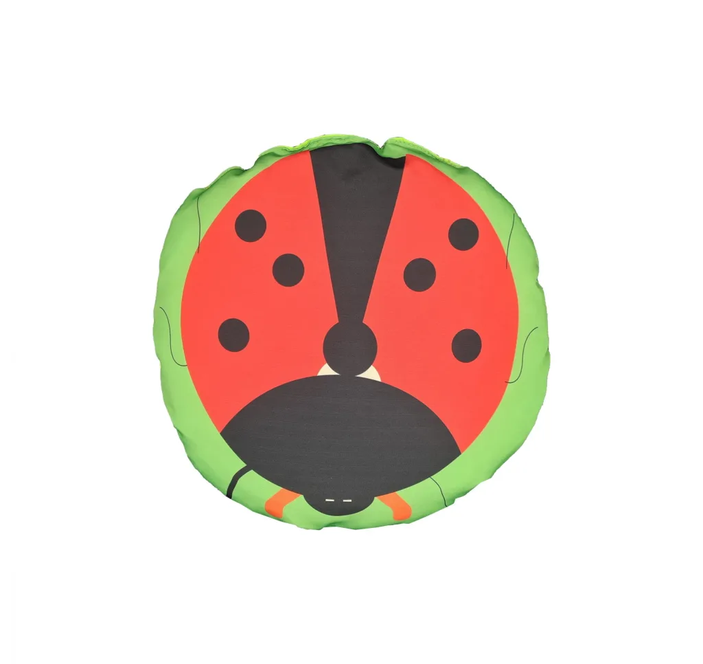Child scatter cushion, fibre-filled, printed as a stylized red and black ladybird with a green border.