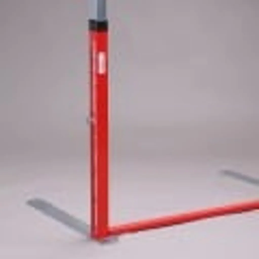 Red adjustable jumping hurdle upright with a horizontal base bar on a plain gray background.