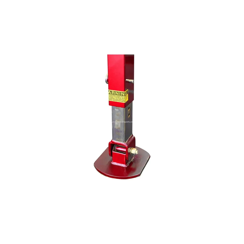 Red adjustable support post for gymnastics rings with a yellow label reading "Warning", exposed metal adjustment tube and red curved base plate.