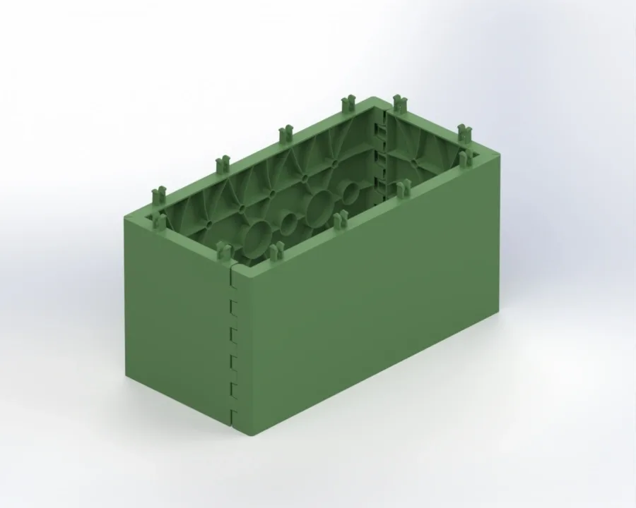 Green rectangular hollow plastic block with ribbed inner walls and interlocking tabs along the top edges.