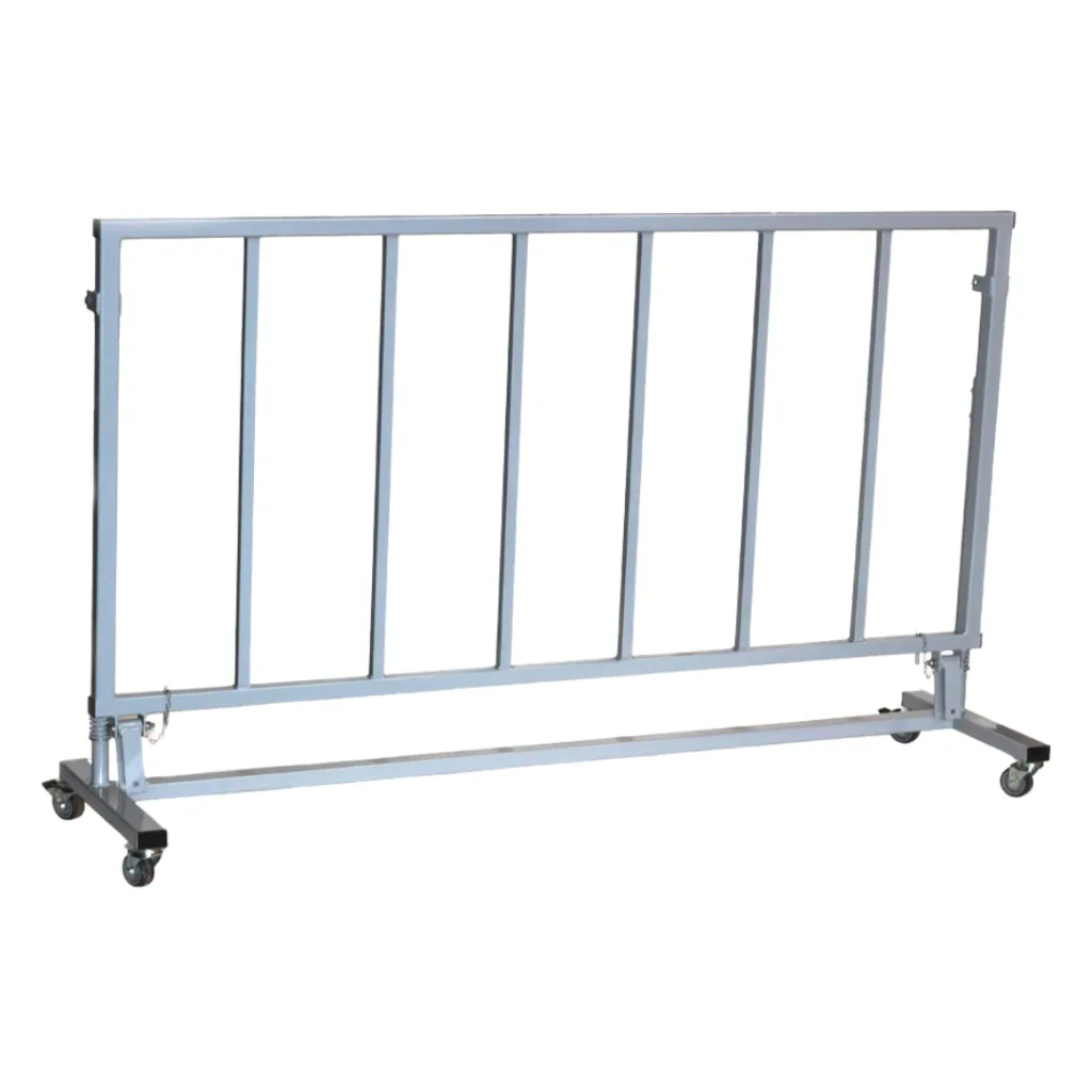Gray metal folding spotting end deck safety frame with vertical bars mounted on a wheeled rectangular base.