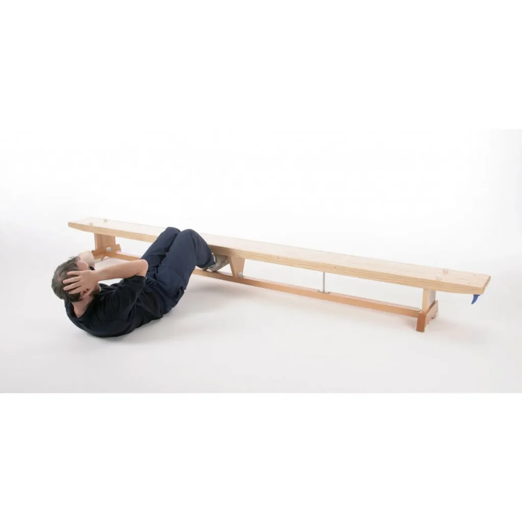 Hardwood balance bench with rubber feet and nylon hooks, with a person doing sit-ups hooked under the bench.