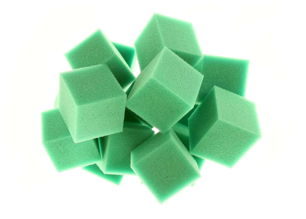 Loose pile of coloured foam cubes for gym pits, showing textured foam faces.