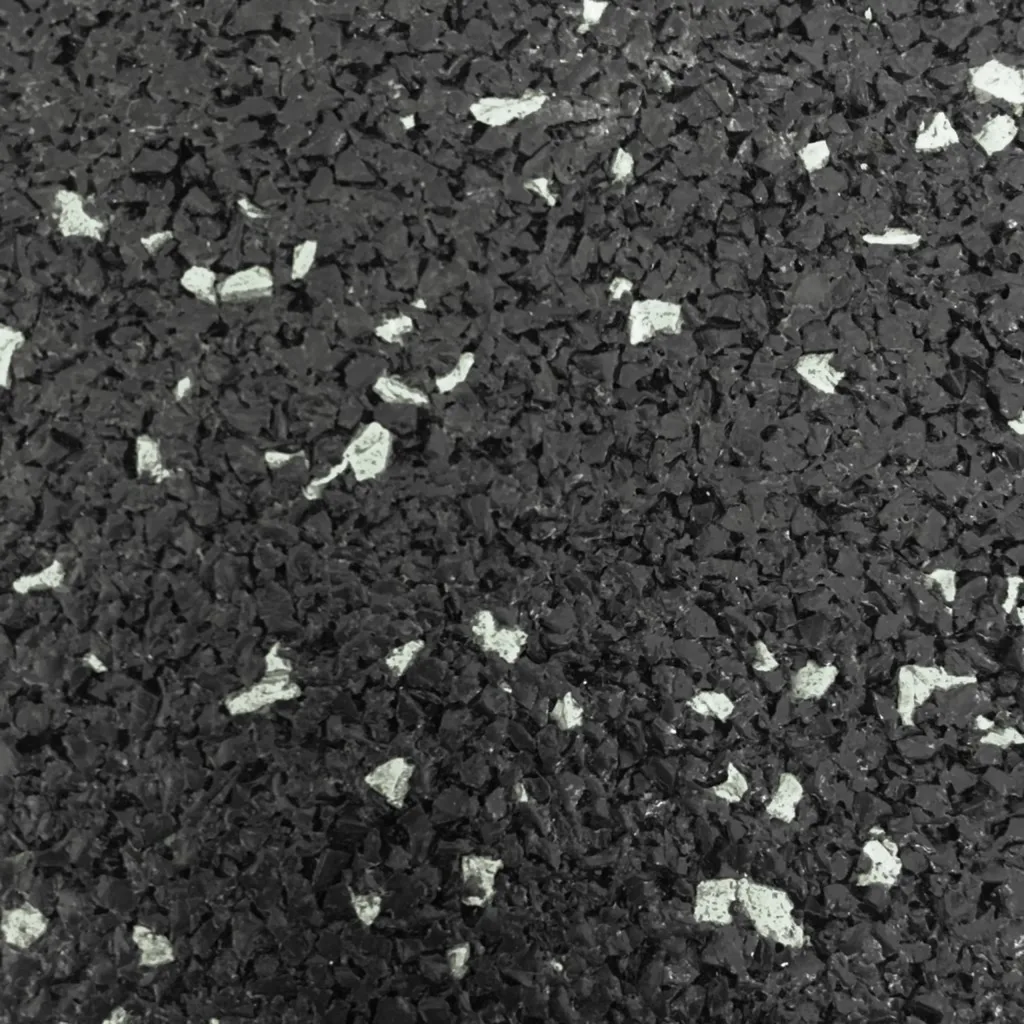 Black rubber flooring sample with scattered white flecks and a coarse granulated texture.