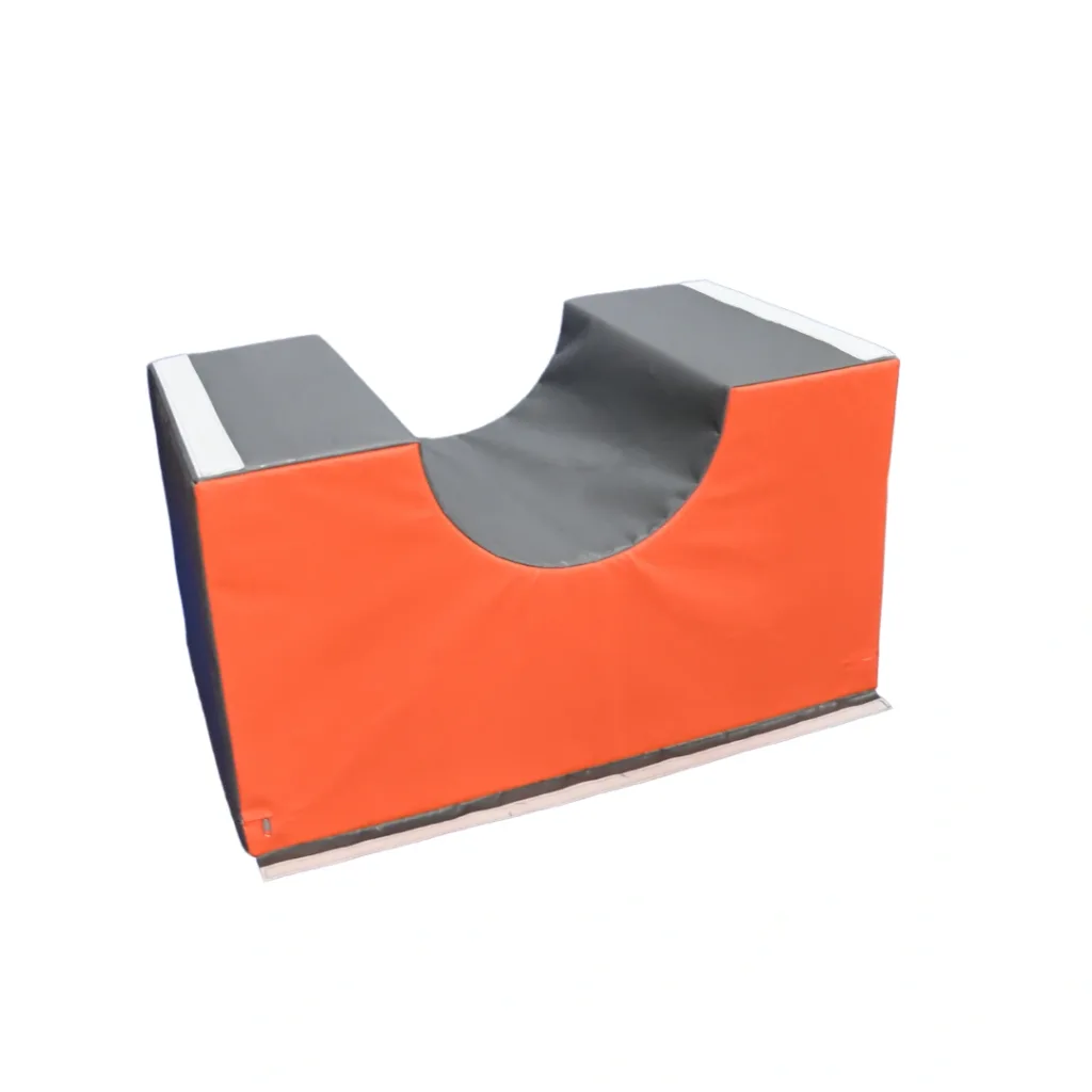 Orange and grey foam gymnastics bridge with a central U-shaped concave top and flat end platforms.