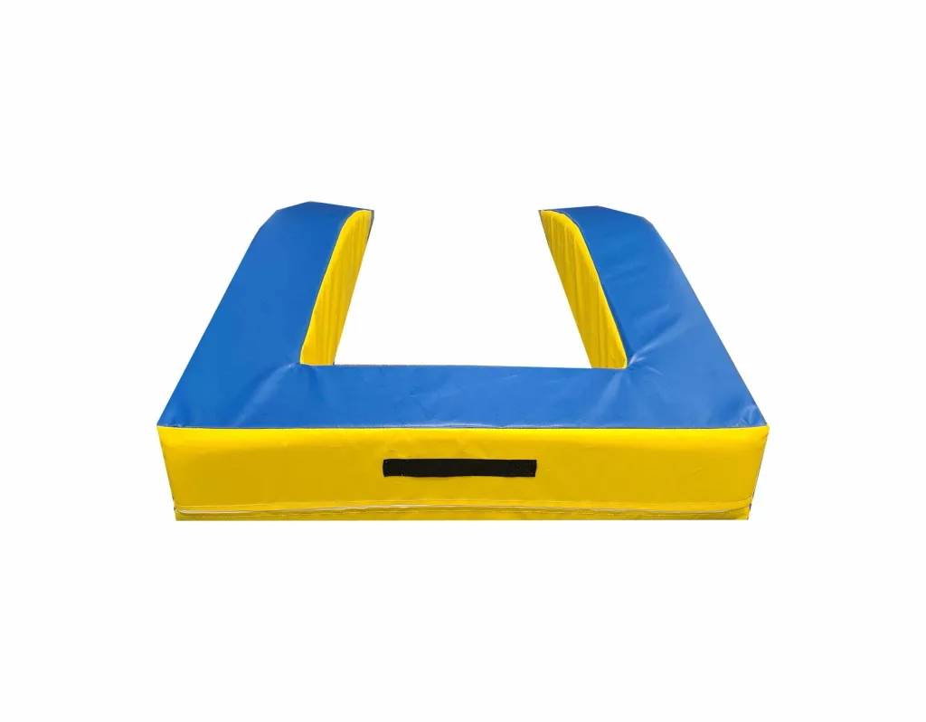 U-shaped springboard surround made from high-density PU foam with a heavy-duty PVC cover, blue top and bottom, yellow sides, and a black carrying handle.